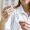 defocused-female-scientist-with-safety-glasses-holding-syringe-with-vaccine